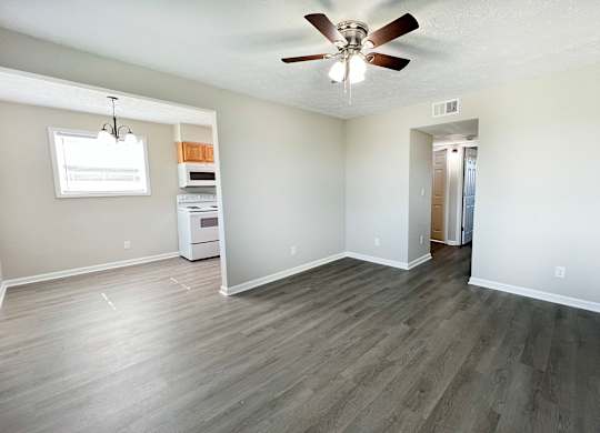A room with a ceiling fan and a window.