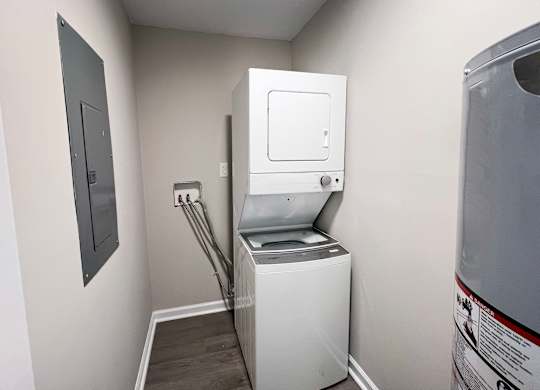 A white washing machine in a small laundry room.