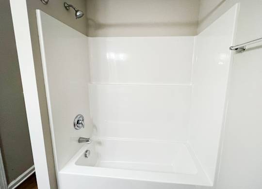A white bathroom with a tub and shower.