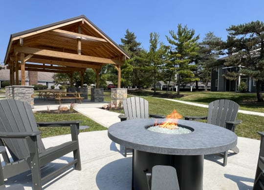 a patio with a fire pit and chairs around it at Deercross Apartments, Ohio, 45236