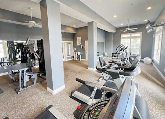 Liberty Crossing a gym with treadmills and other exercise equipment in a large room with windows at The Residences at Liberty Crossing, Columbus, OH, 43235