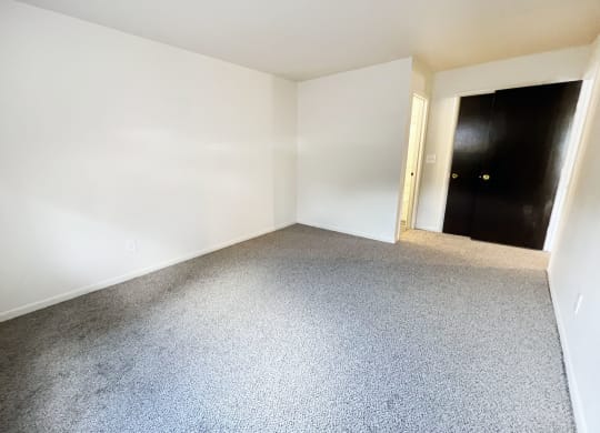 an empty room with white walls and a carpet floor at Four Worlds Apartments, Cincinnati, 45231