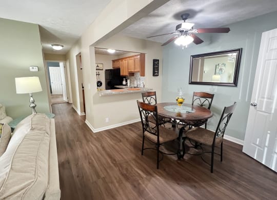 a living room and dining room with a couch and a table at Fox Run Apartments, Cincinnati
