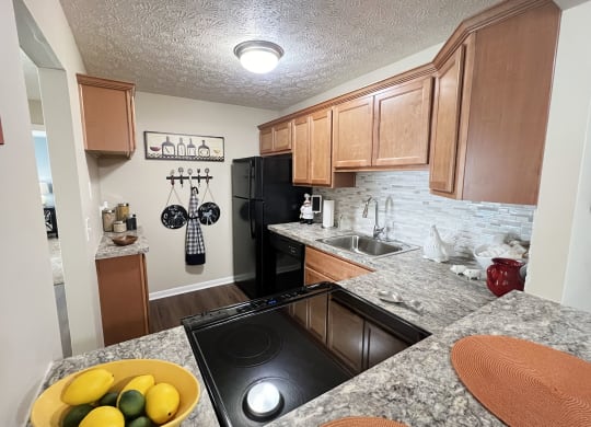 full kitchen with black appliances and granite countertops  at Fox Run Apartments, Cincinnati, OH, 45236