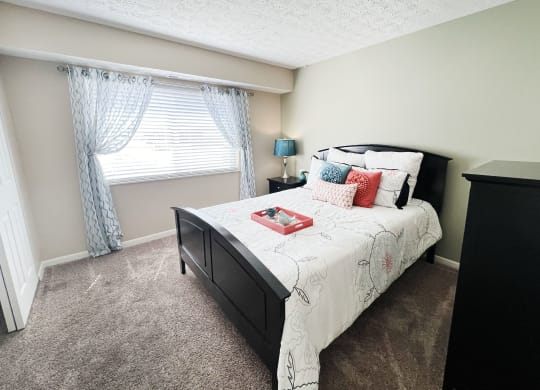 an empty bedroom with a bed and a window  at Fox Run Apartments, Cincinnati, OH, 45236