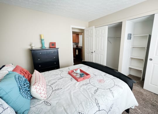 a bedroom with a bed and a closet  at Fox Run Apartments, Cincinnati, OH, 45236