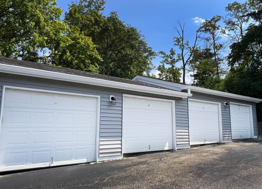 a row of three garage doors on the side of a building at Deercross Apartments, Cincinnati, 45236