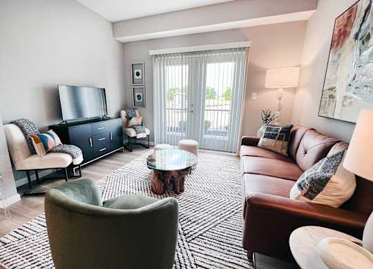 Living Room with a Grey Armchair at Hebron Station Apartments, Kentucky