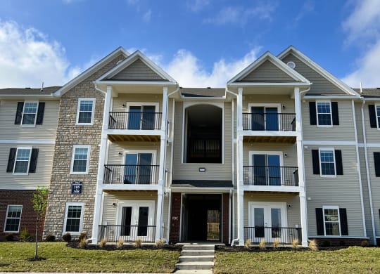 a large apartment building with stairs in front of it