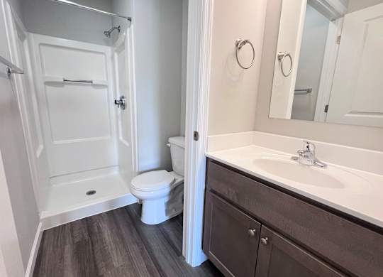 A white toilet and sink in a bathroom.