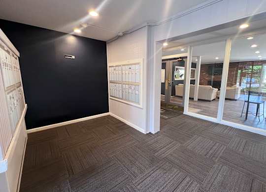 A room with a black wall and a wooden floor.