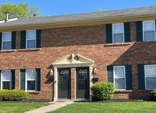 a brick house with green shutters and a front doorat Revere Village Apartments, Centerville