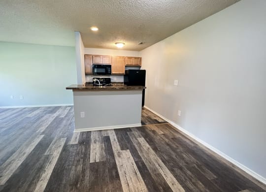 an empty living room and kitchen with a counter top at Eagle Crest Apartments, Galloway, Ohio