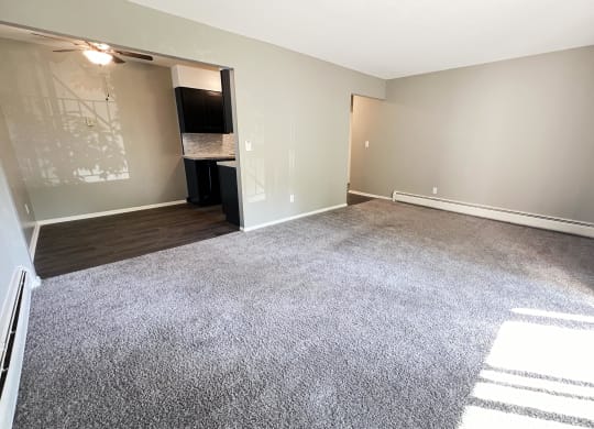 an empty living room with a carpeted floor and a door to a closet at Crown Pointe Apartments, Kentucky, 41014