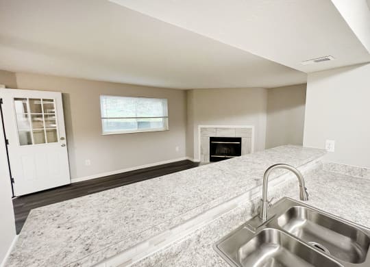 an empty kitchen with a sink and a fireplace at The Vinings Apartments, Cincinnati