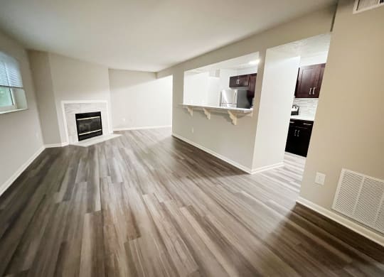 an empty living room with wooden floors and a fireplace at The Vinings Apartments, Cincinnati, 45245
