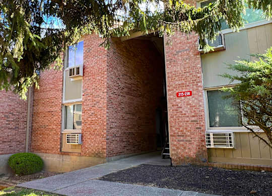 A building entrance with a red sign that says