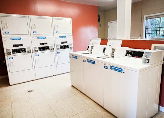 A bank with a white counter and a red wall.