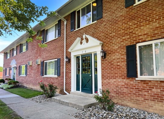 the front of a brick house with a green door at Sharondale Woods Apartments, Ohio, 45241