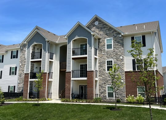 an apartment building with brick and white siding at Parkway Trails, Florence, KY, 41042