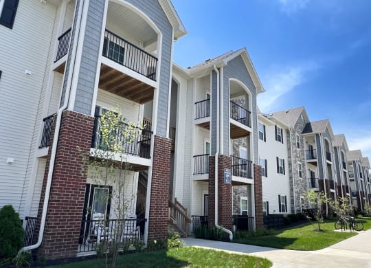 a row of apartments with balconies and a sidewalk  at Parkway Trails, Florence, 41042