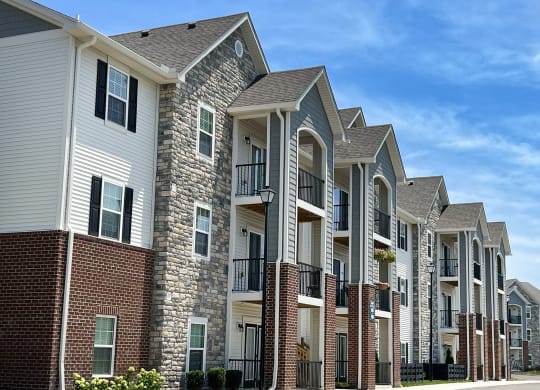 a row of apartment buildings with brick and stone exterior at Parkway Trails, Florence, KY