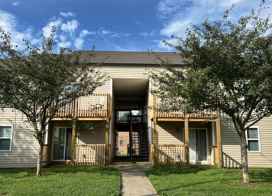 an apartment building with trees and a sidewalk at 450 on Keeneland Apartments, Richmond, 40475