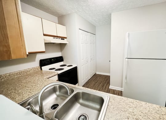 a kitchen with a sink and a refrigerator at 450 on Keeneland Apartments, Kentucky
