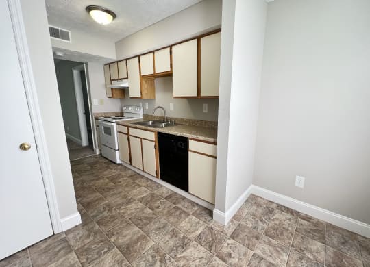 an empty kitchen with a counter top and a sink at 450 on Keeneland Apartments, Richmond, Kentucky