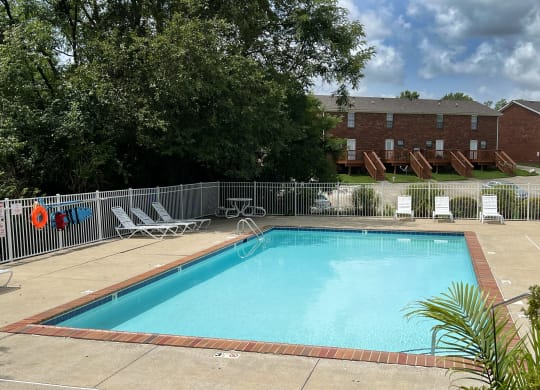 a swimming pool with chairs at 450 on Keeneland Apartments, Richmond
