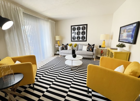 a living room with yellow furniture and a checkered floor at Miamisburg by the Mall, Miamisburg, 45342