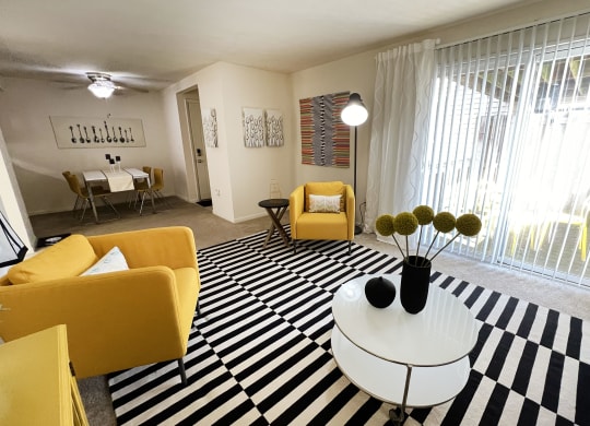 a living room with yellow furniture and a black and white rug at Miamisburg by the Mall, Miamisburg, OH, 45342
