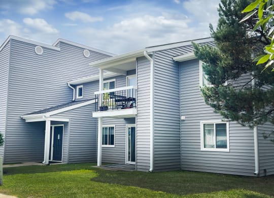 a white house with a yard and a balcony at Deercross Apartments, Cincinnati, Ohio