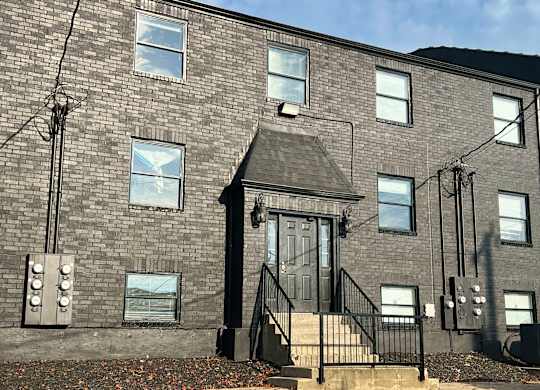 the front of a brick building with a door