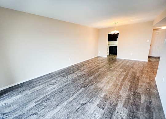 an empty living room with vinyl flooring and white walls at Indian Lookout Apartments, Cincinnati, OH