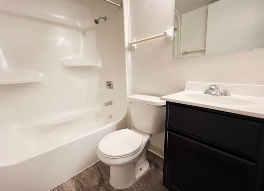 a bathroom with a toilet and a tub and a sink at Indian Lookout Apartments, Cincinnati