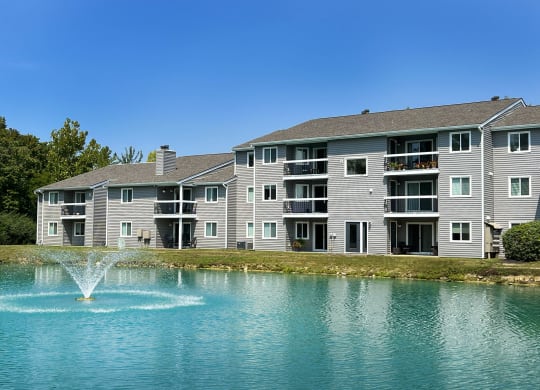 a fountain in a lake in front of an apartment building at Deercross Apartments, Cincinnati, Ohio