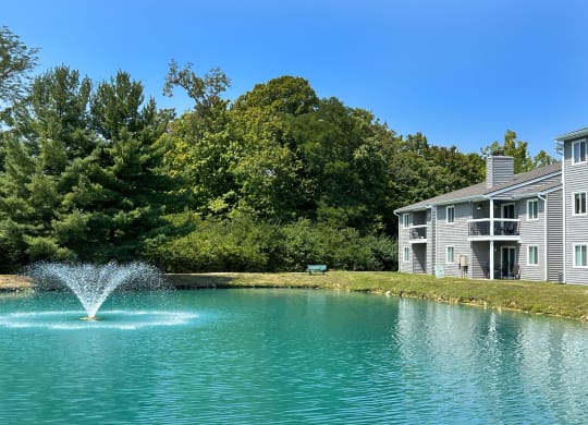 a fountain in the middle of a pond in front of an apartment building at Deercross Apartments, Ohio, 45236