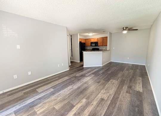 A room with wooden flooring and a ceiling fan.