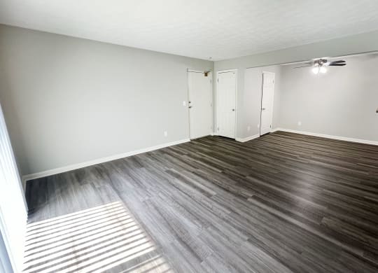 an empty living room with wood floors and white walls at Fox Run Apartments, Cincinnati
