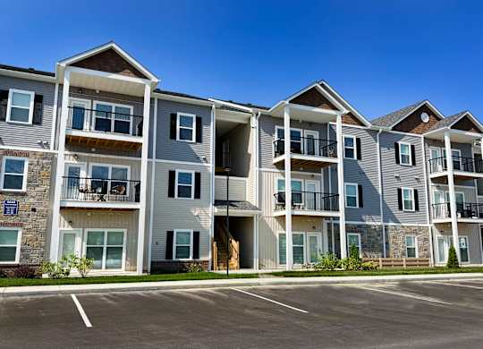 A large apartment complex with multiple balconies and doors.
