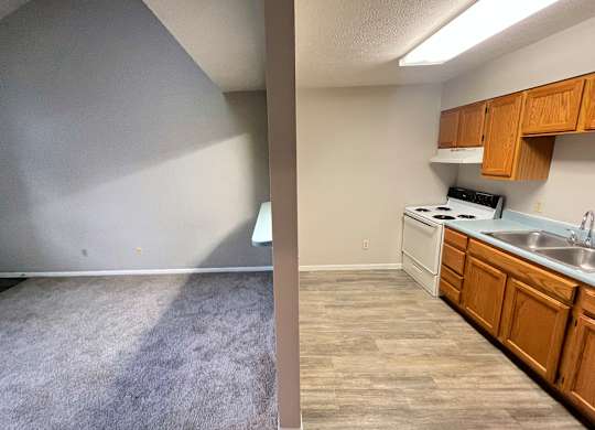 A split image of a kitchen and a living room.