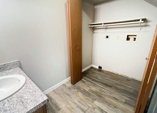 A bathroom with a sink and a towel bar.