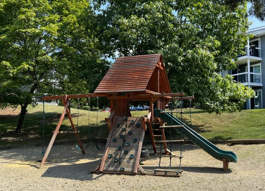 a playground with a swing set and a slide at Deercross Apartments, Ohio