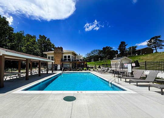 A large swimming pool with a building in the background.