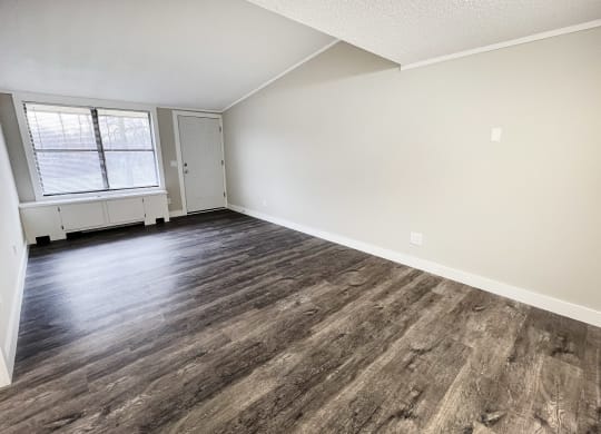 an empty living room with wood flooring and a window  at Wentworth Estates Apartments, Florence, Kentucky