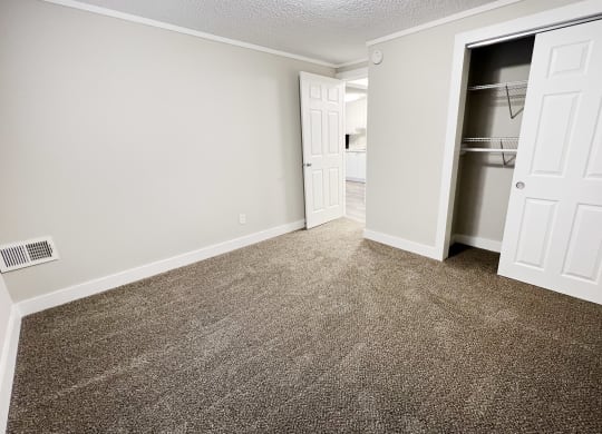 an empty room with carpet and a closet  at Wentworth Estates Apartments, Florence, Kentucky
