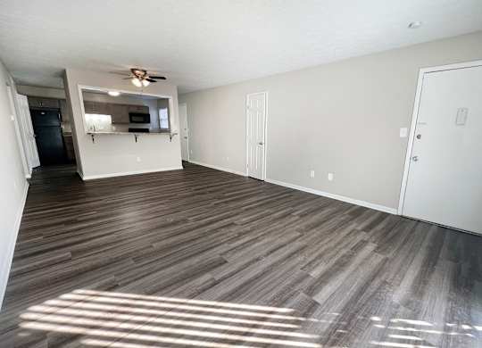 an empty living room with wood flooring and a ceiling fan at Revere Village Apartments, Centerville, OH, 45458