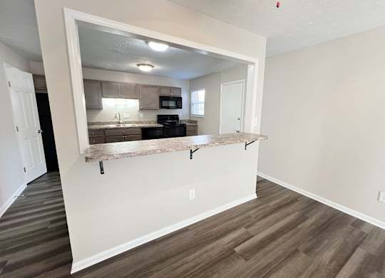 a view of a kitchen from a living room with a counter at Revere Village Apartments, Centerville, 45458
