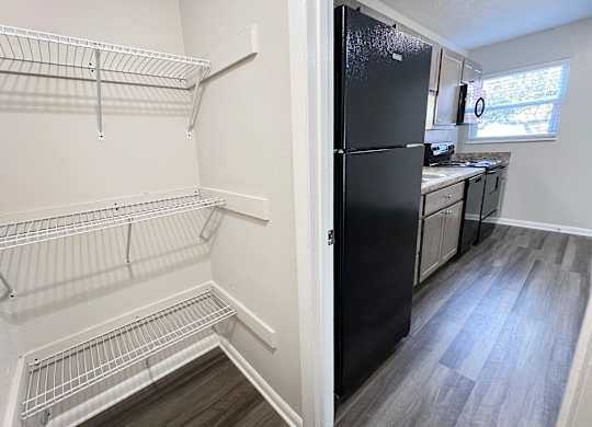 an empty kitchen with a refrigerator and a walk in closet at Revere Village Apartments, Centerville